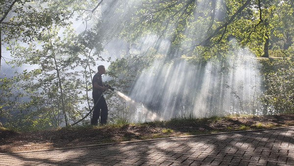 Brandweer blust buitenbrandje nabij begraafplaats